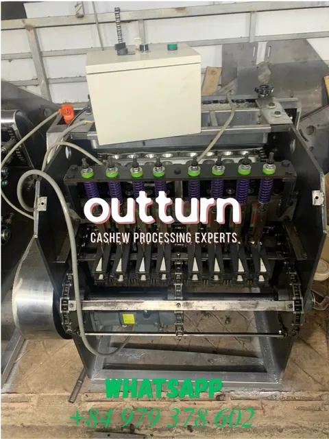 OUTTURN 8-head cashew nut cutting machine showing eight rotary cutting cups arranged around the central turret